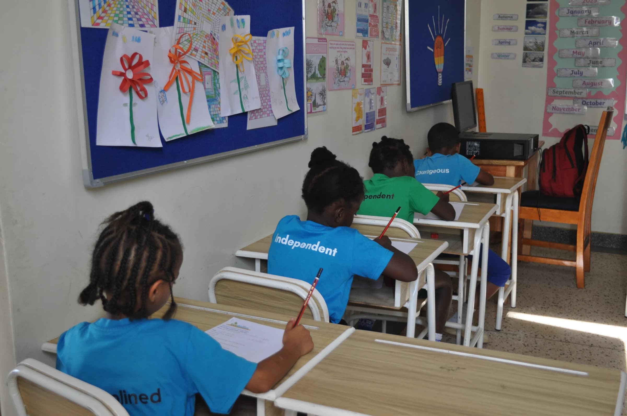 A child working independently with learning materials on a classroom mat at Eco-Bloom