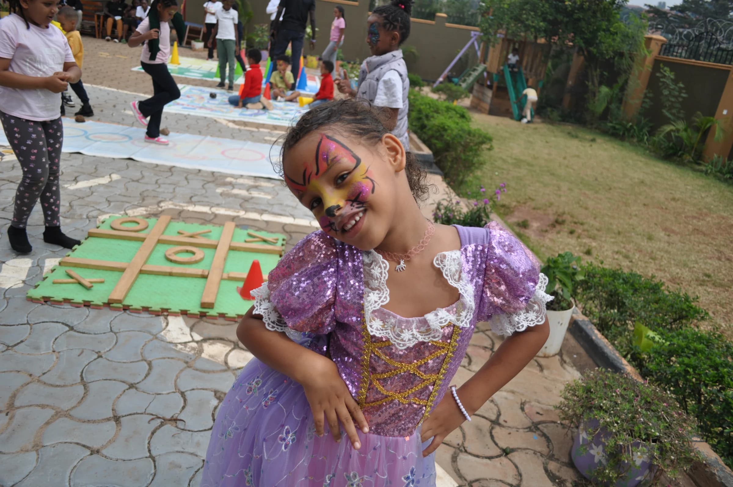 An Eco-Bloom pupil in a purple costume smiling during community day