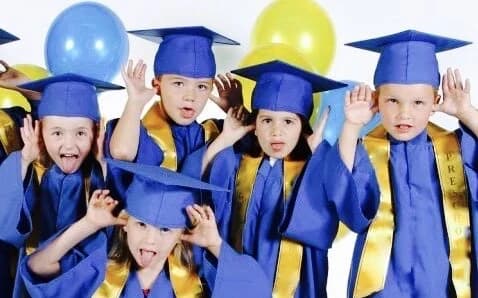 Eco-Bloom children in blue caps and gowns at last year's graduation
