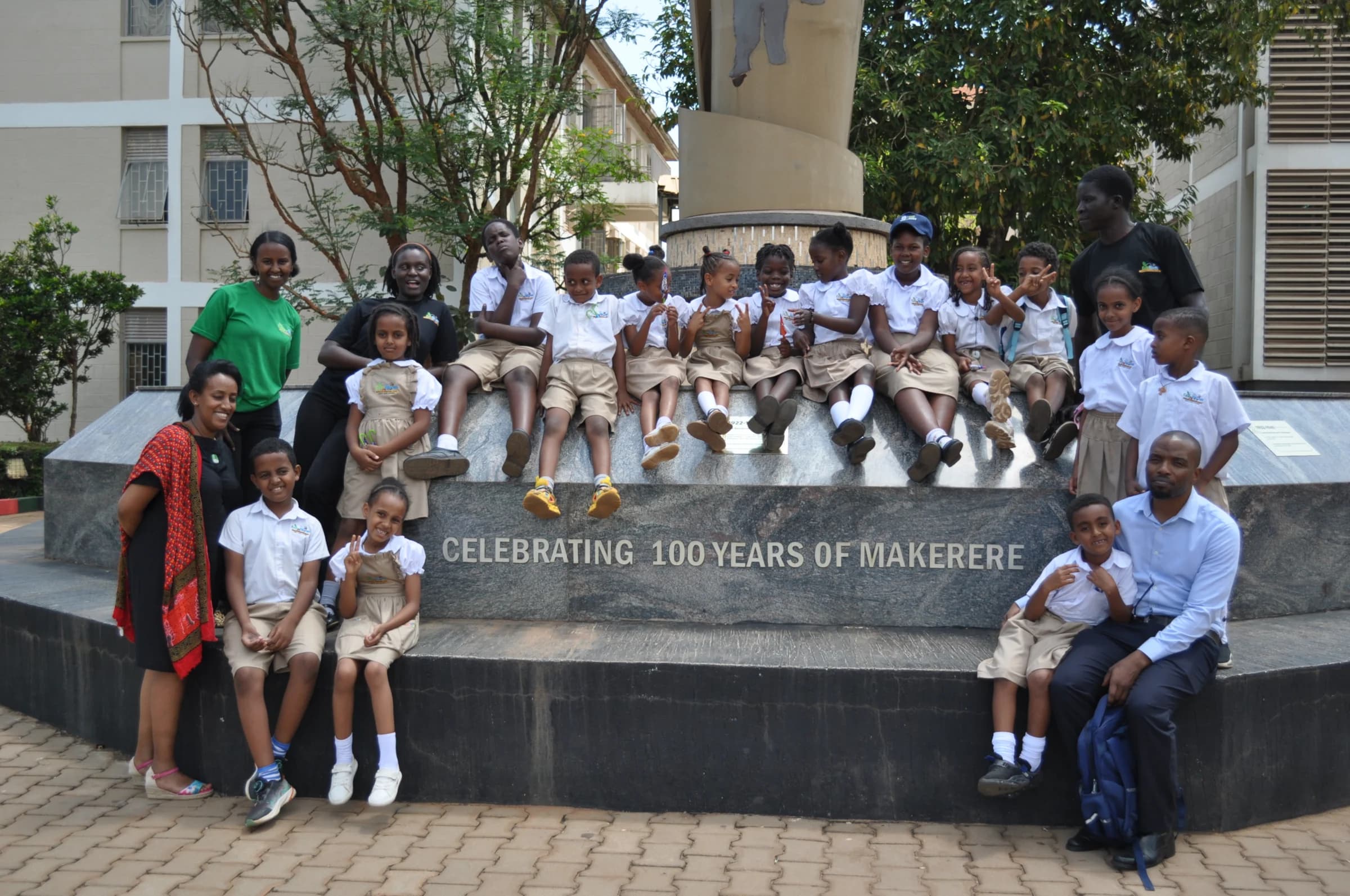 Eco-Bloom pupils and guides at Makerere University's centenary monument