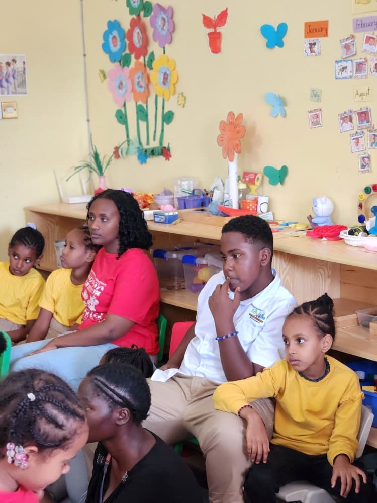 Eco-Bloom pupils and adults gathered in the decorated classroom