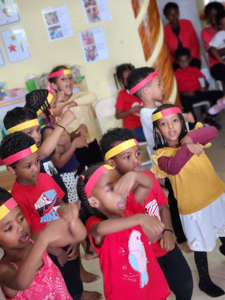 Eco-Bloom pupils performing in red, yellow and black