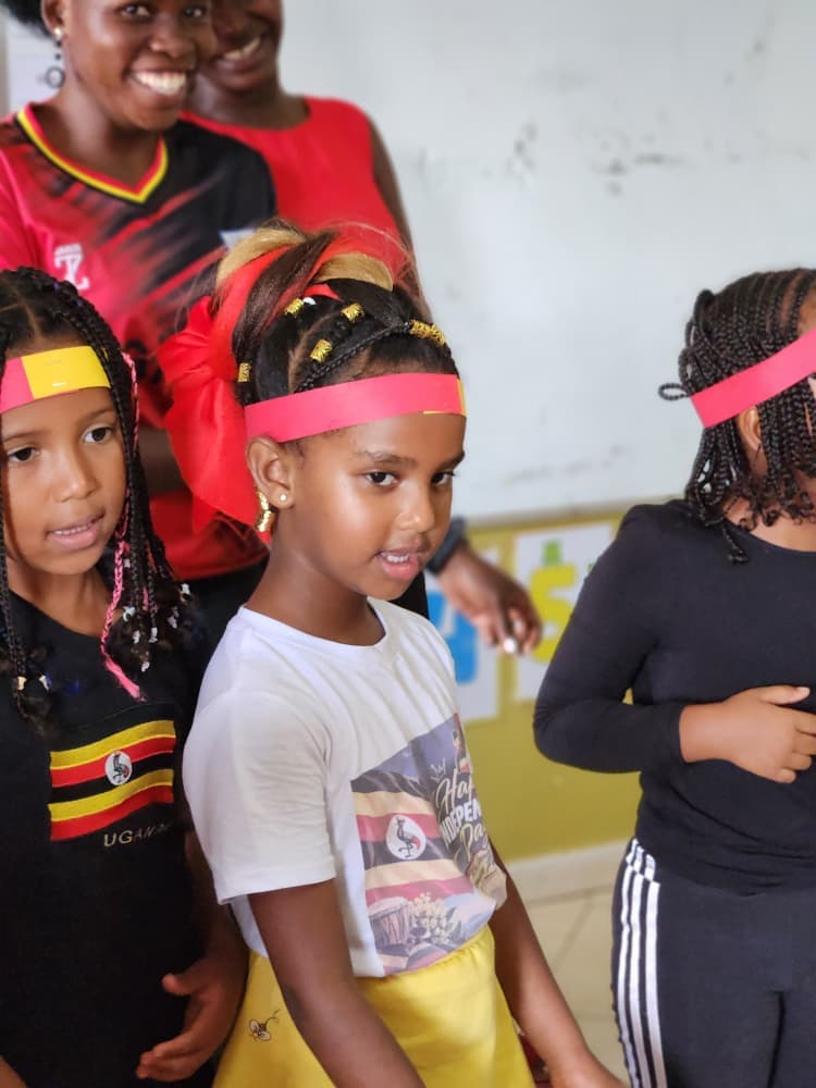 Pupils wearing Uganda-coloured headbands during the celebration