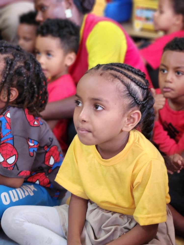 A young Eco-Bloom pupil watching the programme