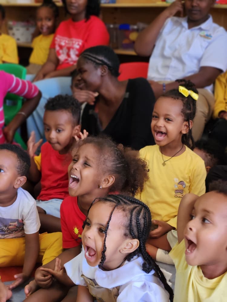 Young Eco-Bloom children laughing during the celebration