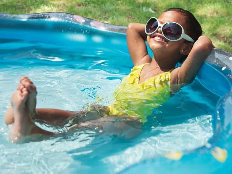 Children playing with water and plants in the garden