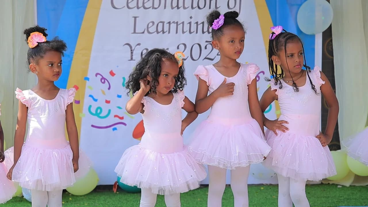 Eco-Bloom children in ballet costumes performing on the Celebration of Learning stage