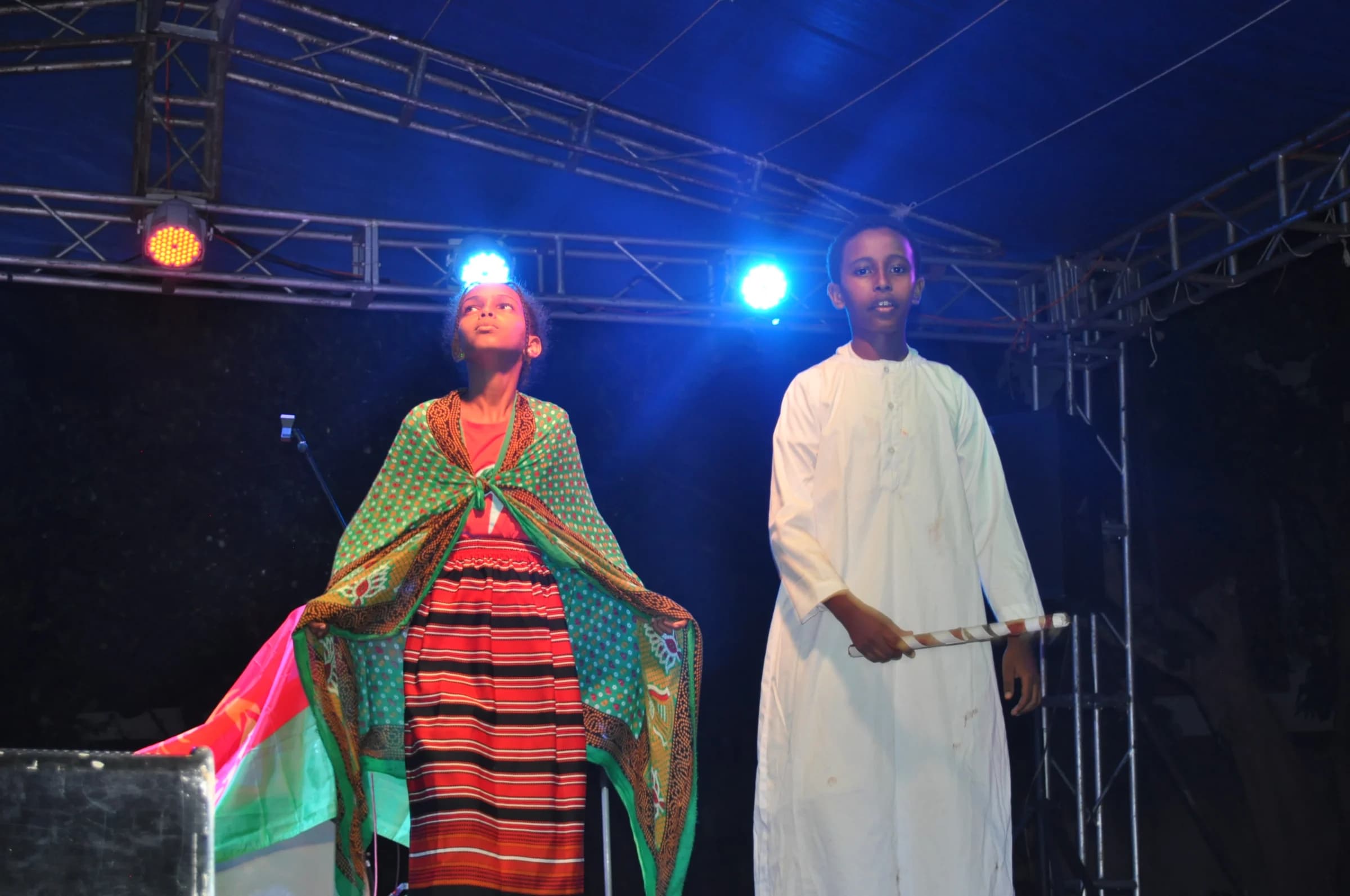 Eco-Bloom pupils performing together in cultural dress on stage