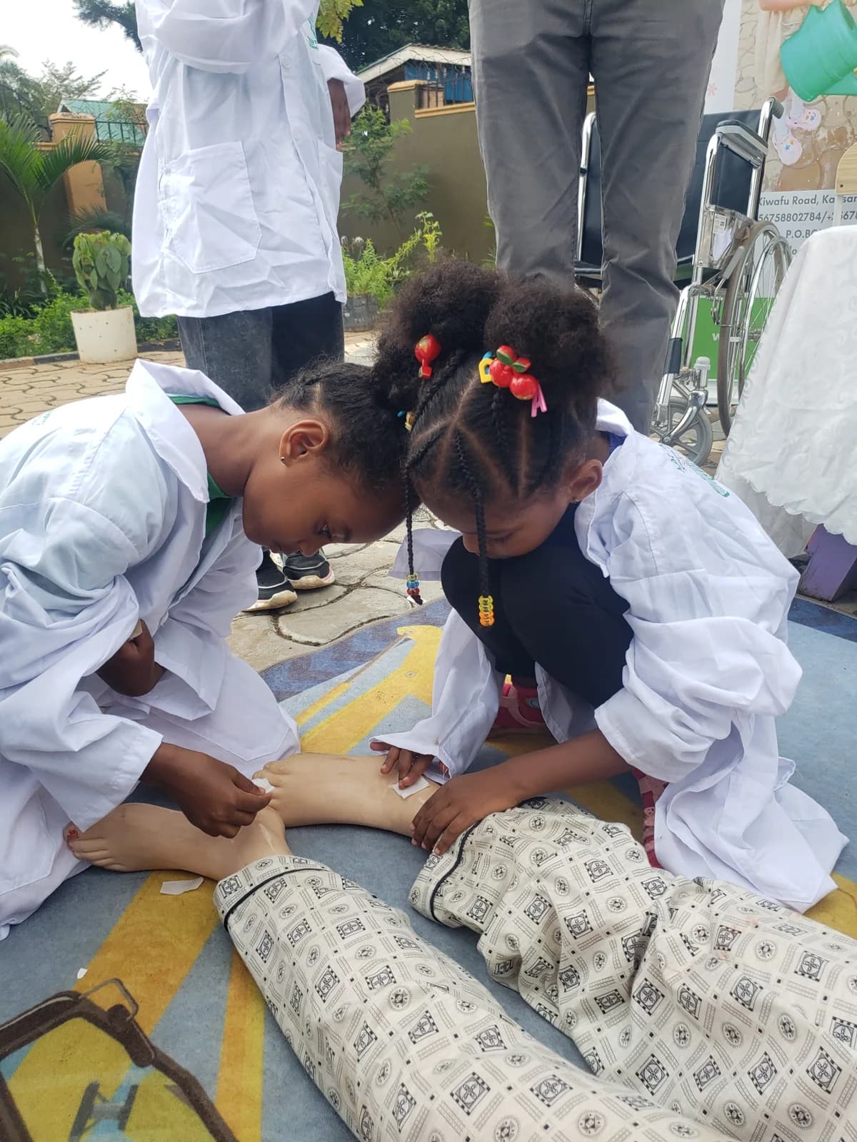 Eco-Bloom children practising bandaging during a first aid activity